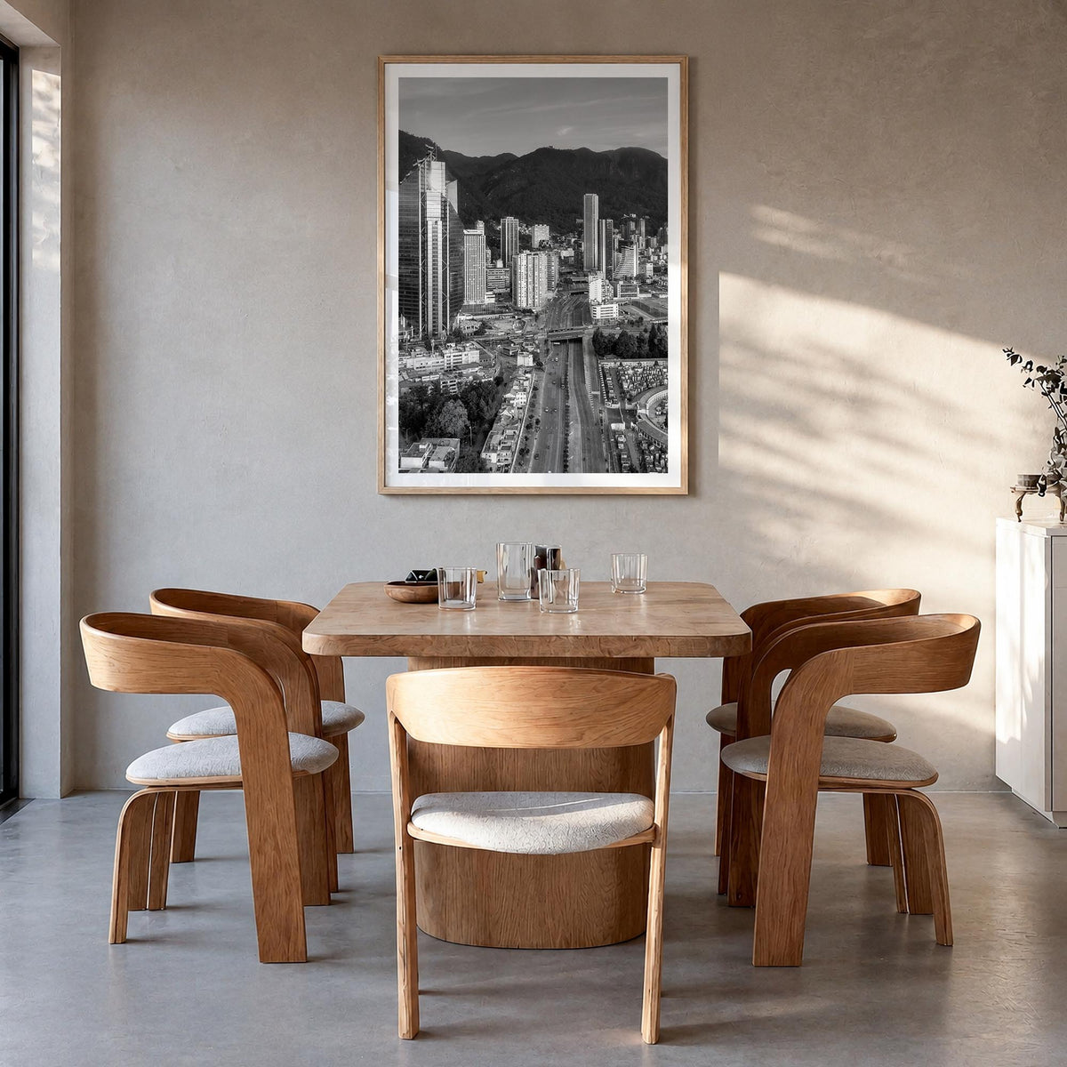 Bogotá black & white photo poster of Colombia – vertical wall art in natural wood frame with white border, hanging on wall