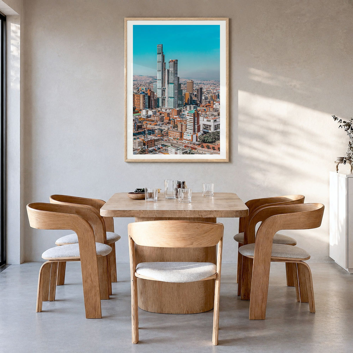 Bogotá Photo No 1 Poster in a natural wood frame, hanging in a dining room, white border