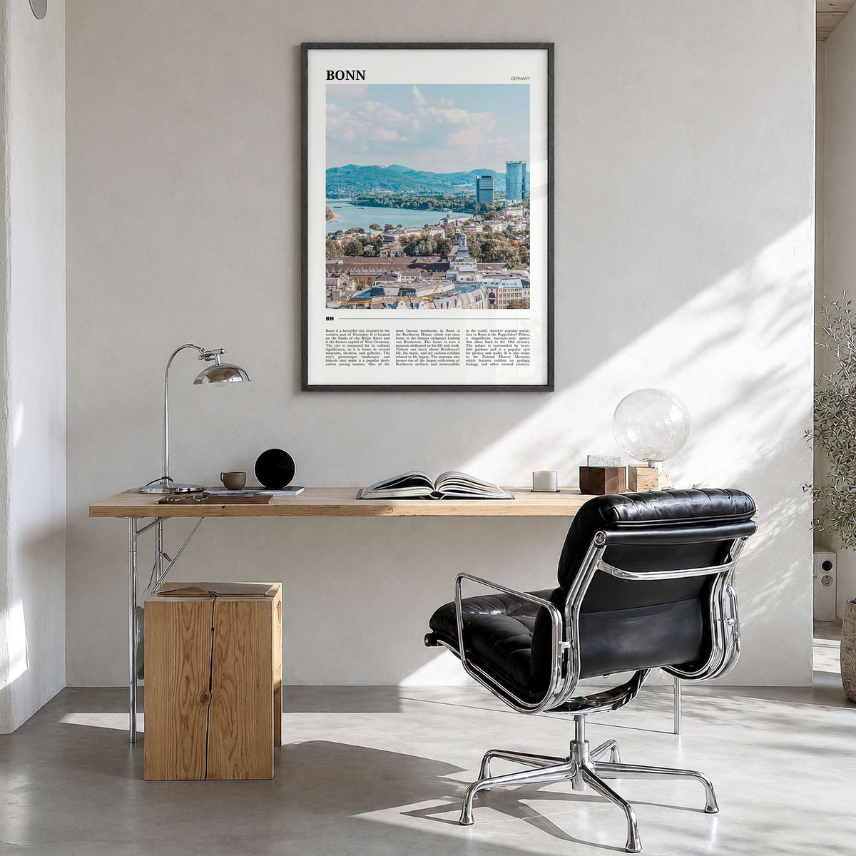 Bonn Travel Poster in a black wood frame, hanging in a bright home office