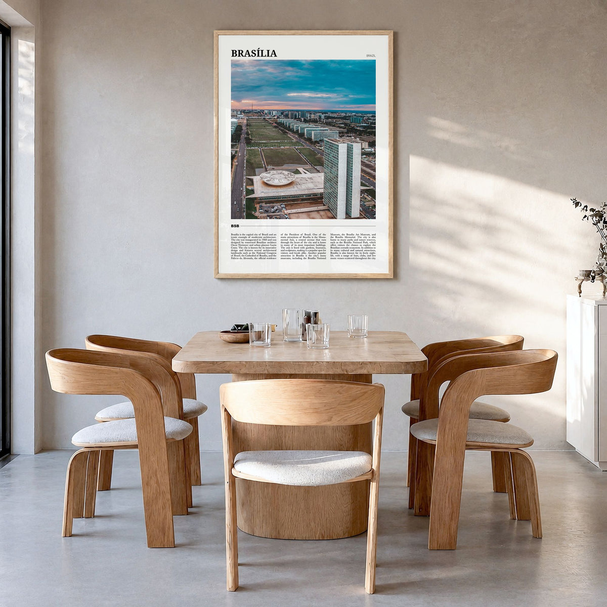 Brasília Travel Poster in a natural wood frame, hanging in a dining room