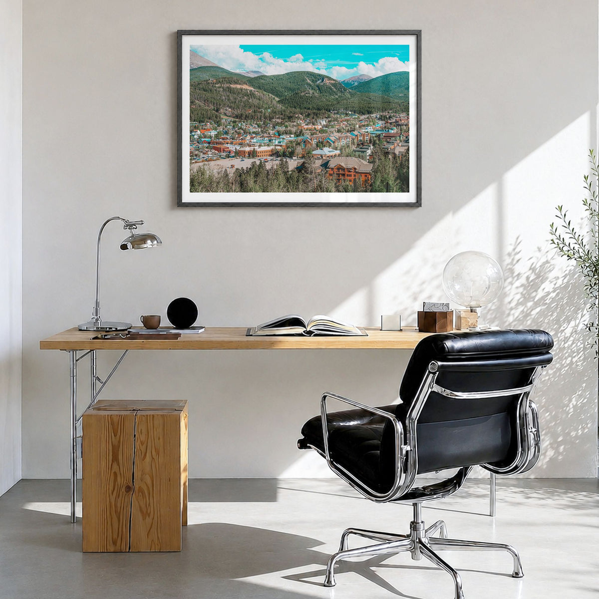 Breckenridge Photo Poster in a black wood frame, hanging in a bright home office, white border