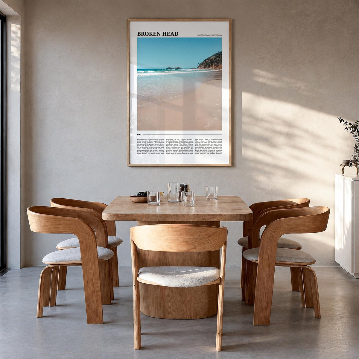 Broken Head colorful travel poster of Australia – vertical wall art in natural wood frame, hanging on wall