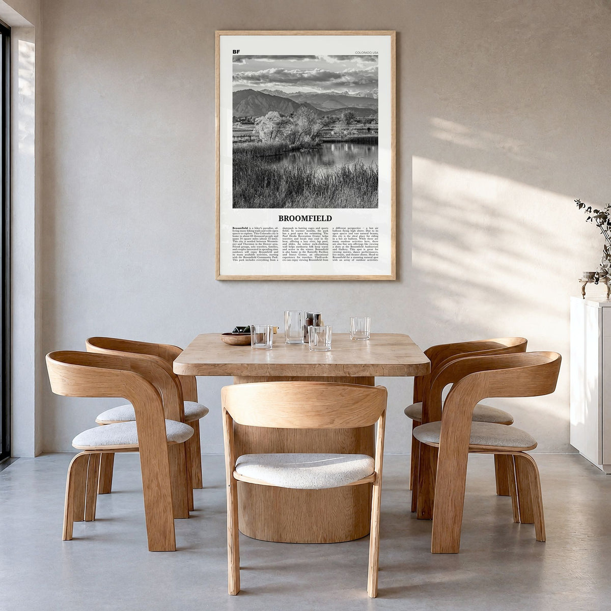 Broomfield Newspaper Poster in a natural wood frame, hanging in a dining room