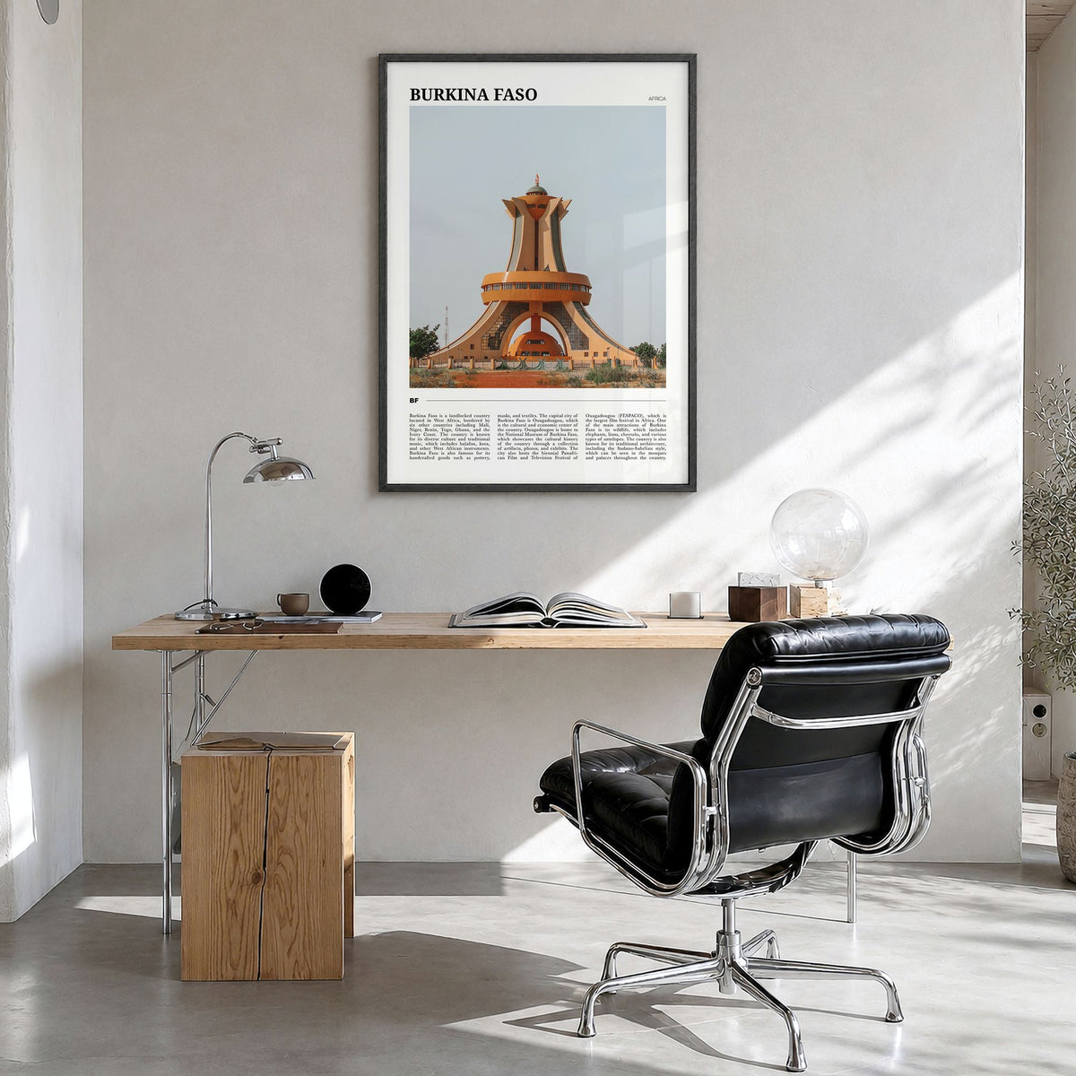 Burkina Faso Travel Poster in a black wood frame, hanging in a bright home office