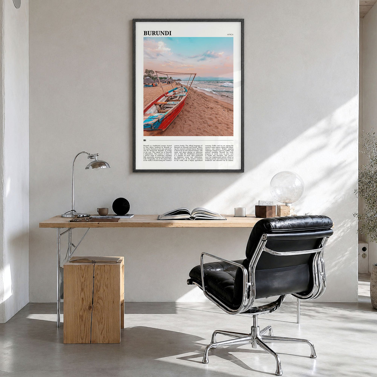 Burundi Travel Poster in a black wood frame, hanging in a bright home office