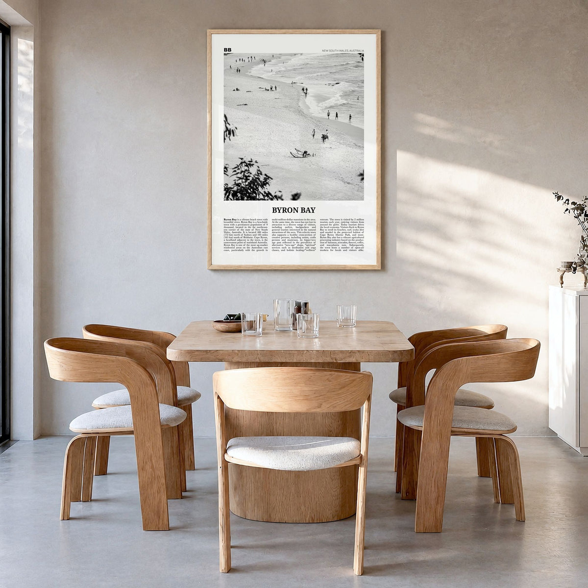 Byron Bay Newspaper No 1 Poster in a natural wood frame, hanging in a dining room