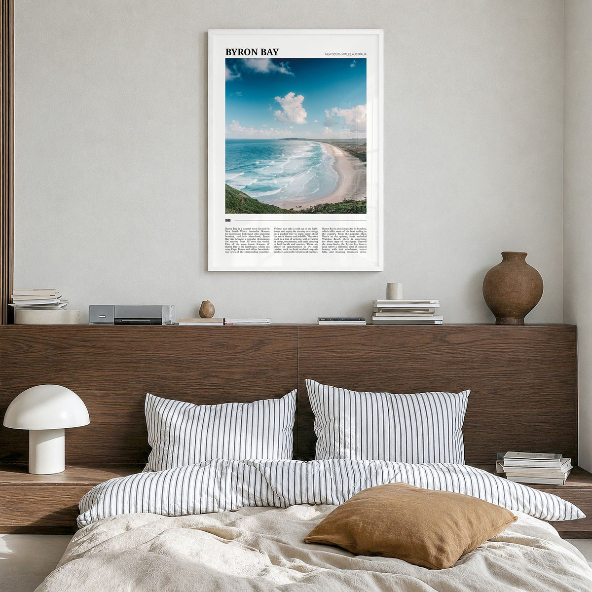 Byron Bay Travel No 1 Poster in a white wood frame, hanging in a bedroom