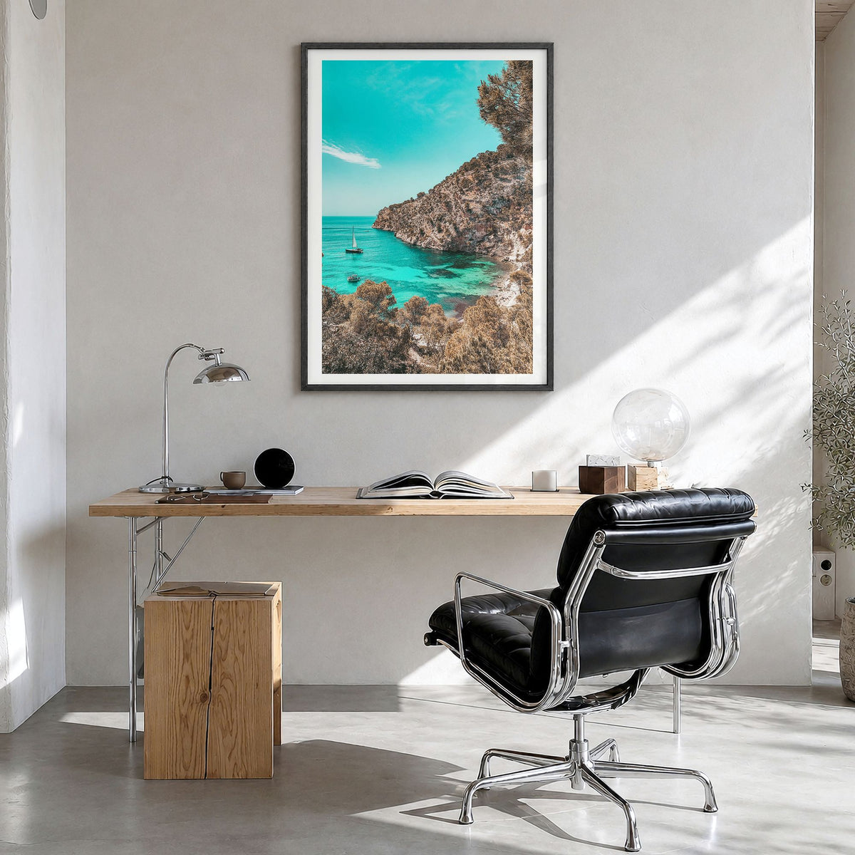 Cala Blanca Photo Poster in a black wood frame, hanging in a bright home office, white border
