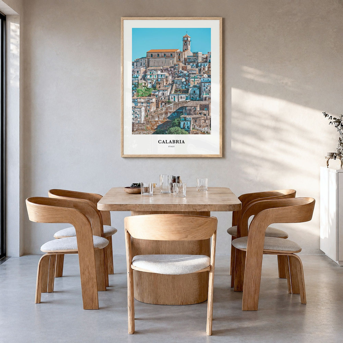 Calabria Classic No 2 Poster in a natural wood frame, hanging in a dining room