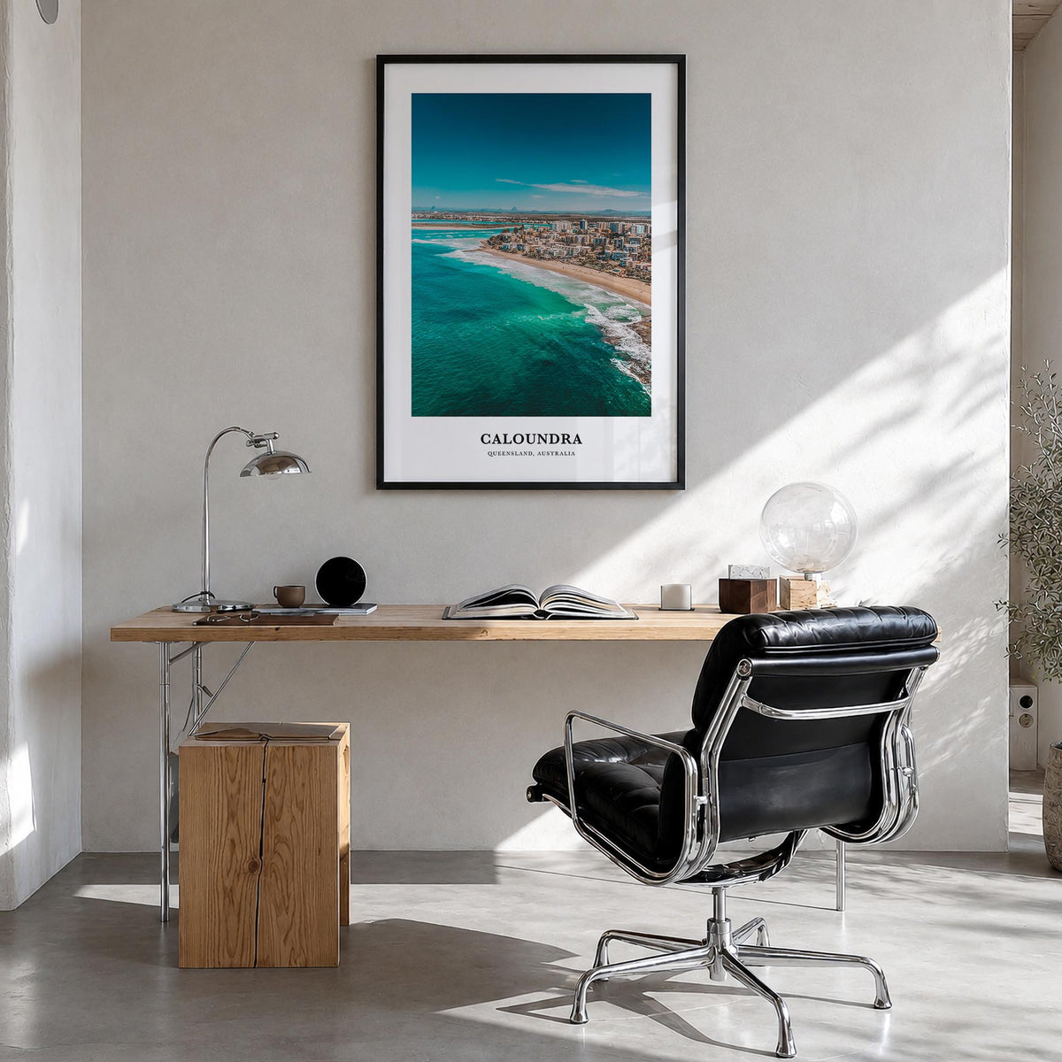 Caloundra colorful classic poster of Australia – vertical wall art in black wood frame, hanging on wall