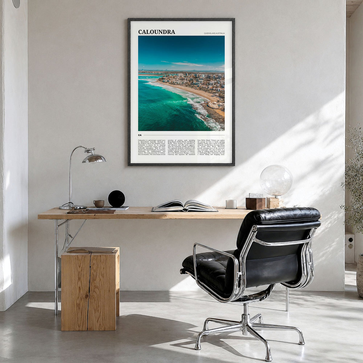 Caloundra Travel Poster in a black wood frame, hanging in a bright home office
