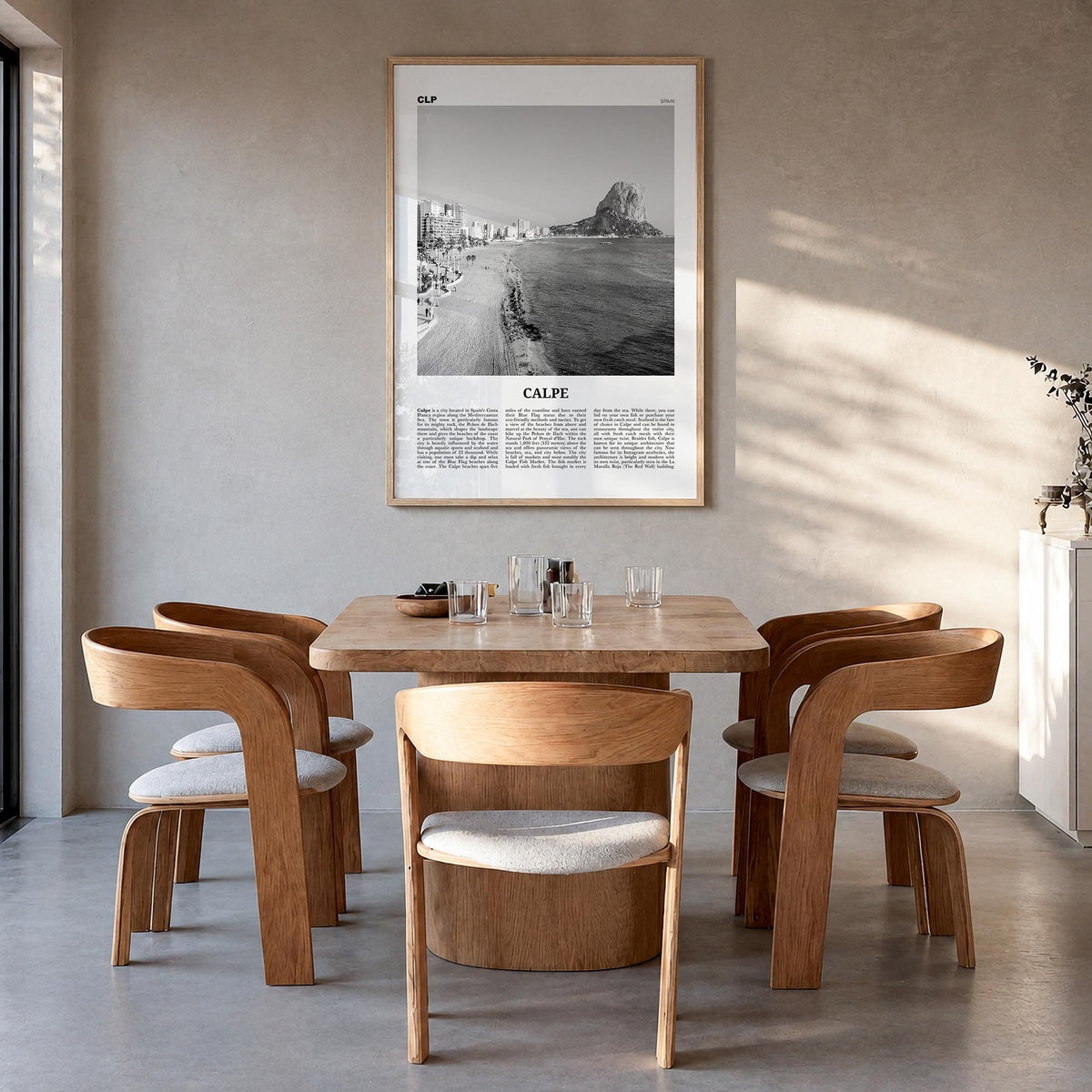 Calpe black & white newspaper poster of Spain – vertical wall art in natural wood frame, hanging on wall