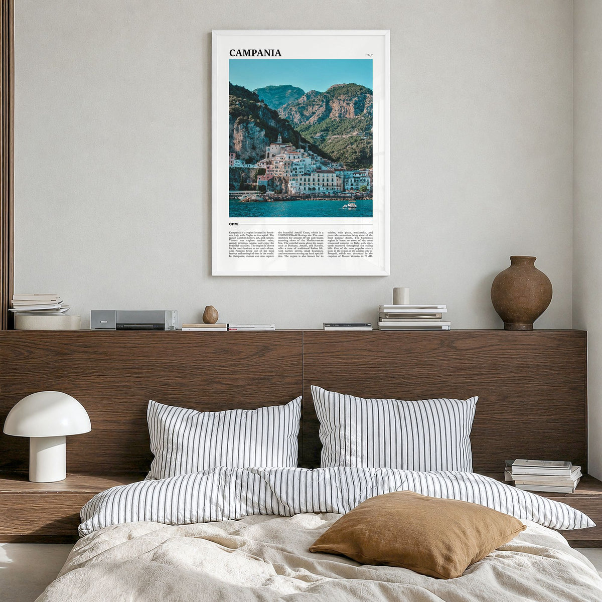 Campania Travel Poster in a white wood frame, hanging in a bedroom
