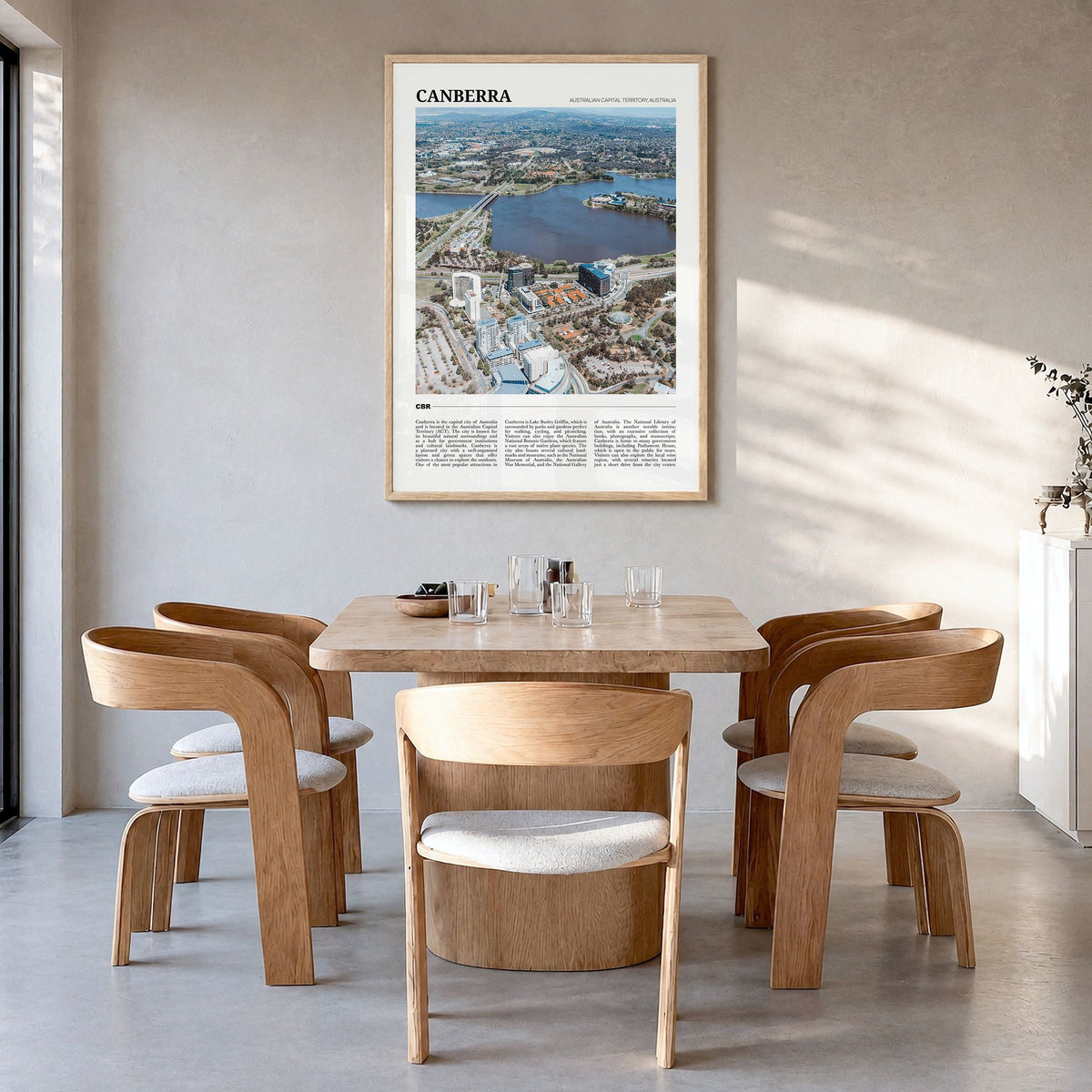 Canberra Travel Poster in a natural wood frame, hanging in a dining room