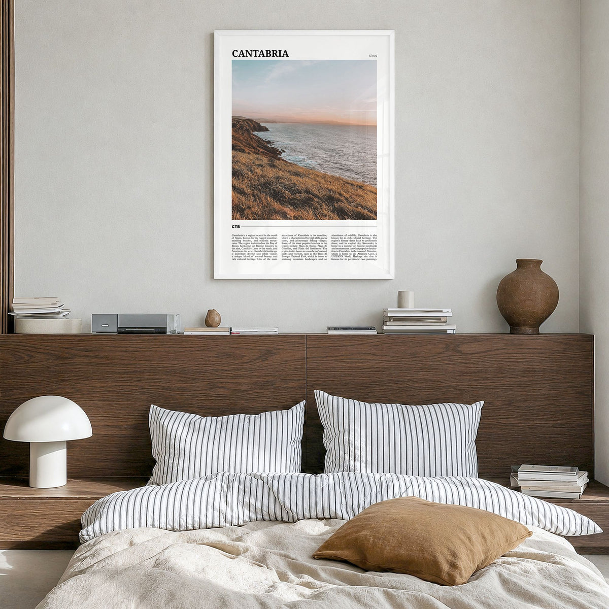 Cantabria Travel Poster in a white wood frame, hanging in a bedroom