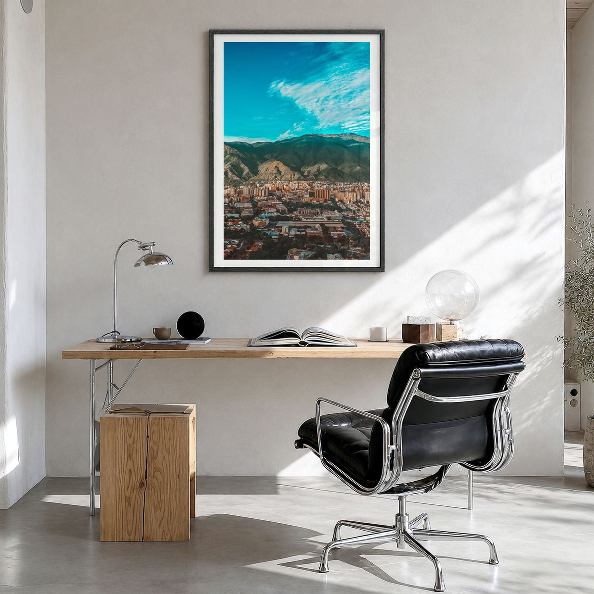 Caracas Photo Poster in a black wood frame, hanging in a bright home office, white border
