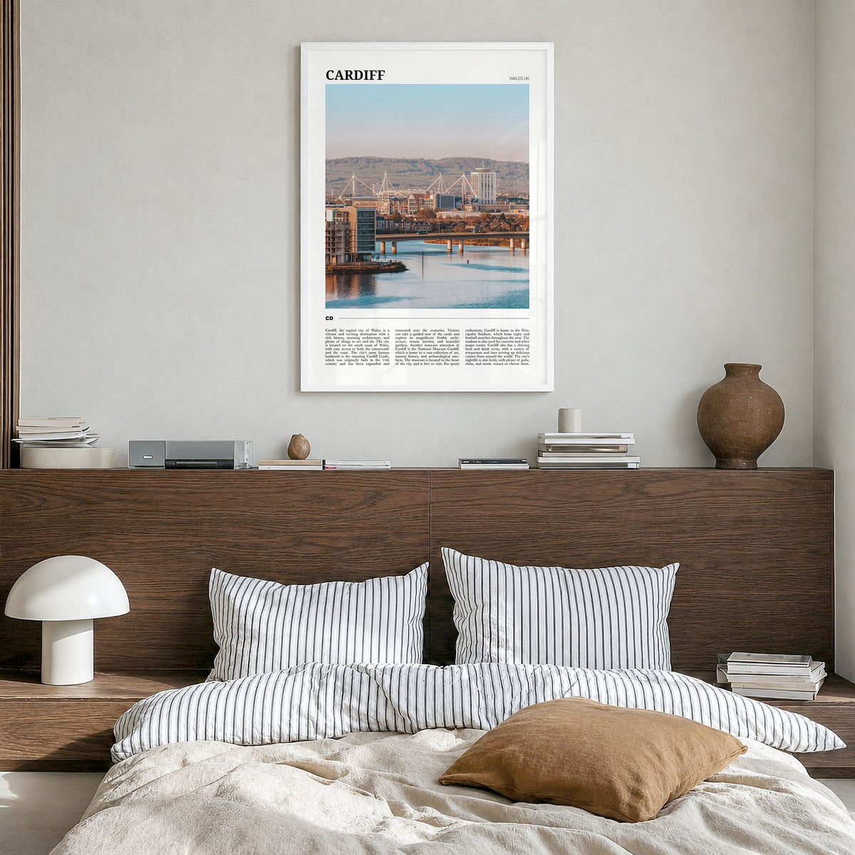 Cardiff Travel Poster in a white wood frame, hanging in a bedroom