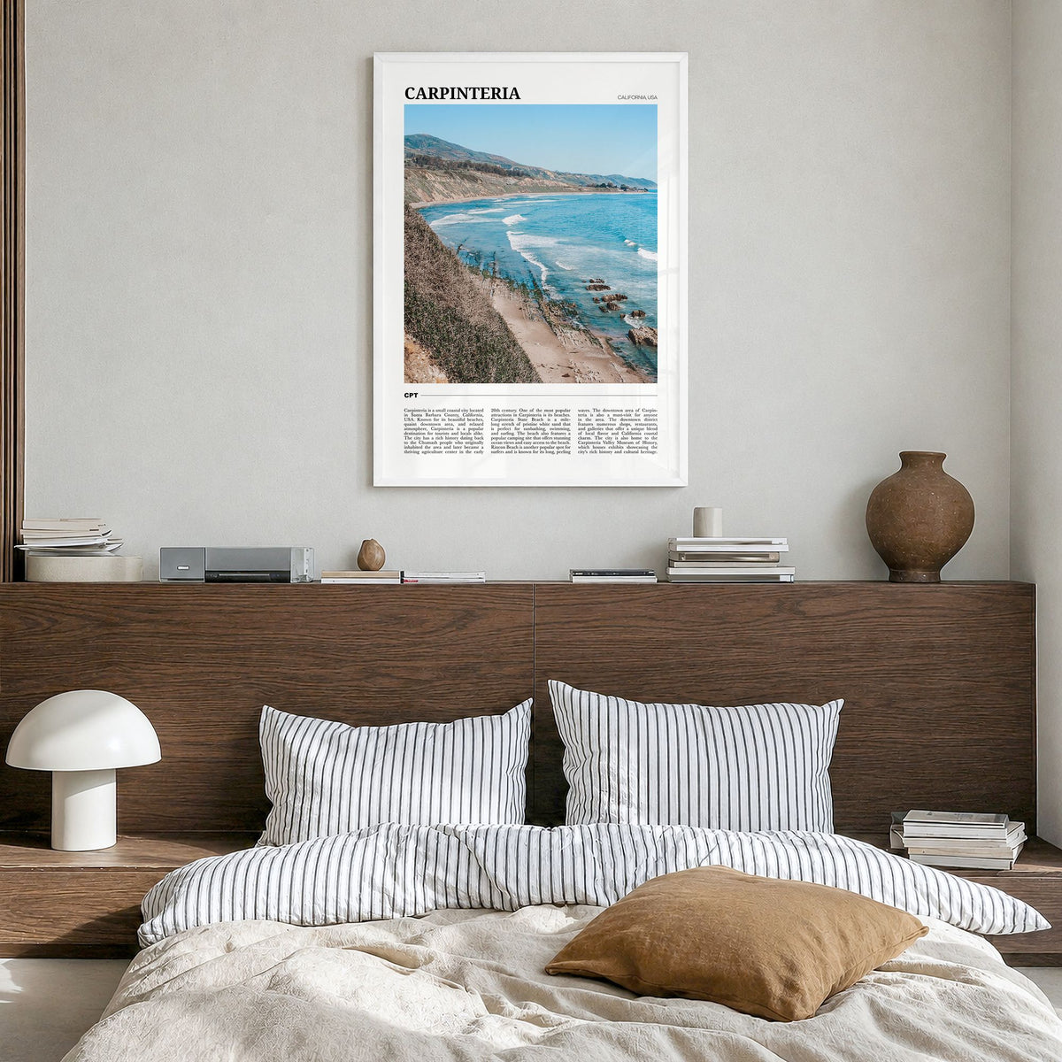 Carpinteria Travel Poster in a white wood frame, hanging in a bedroom