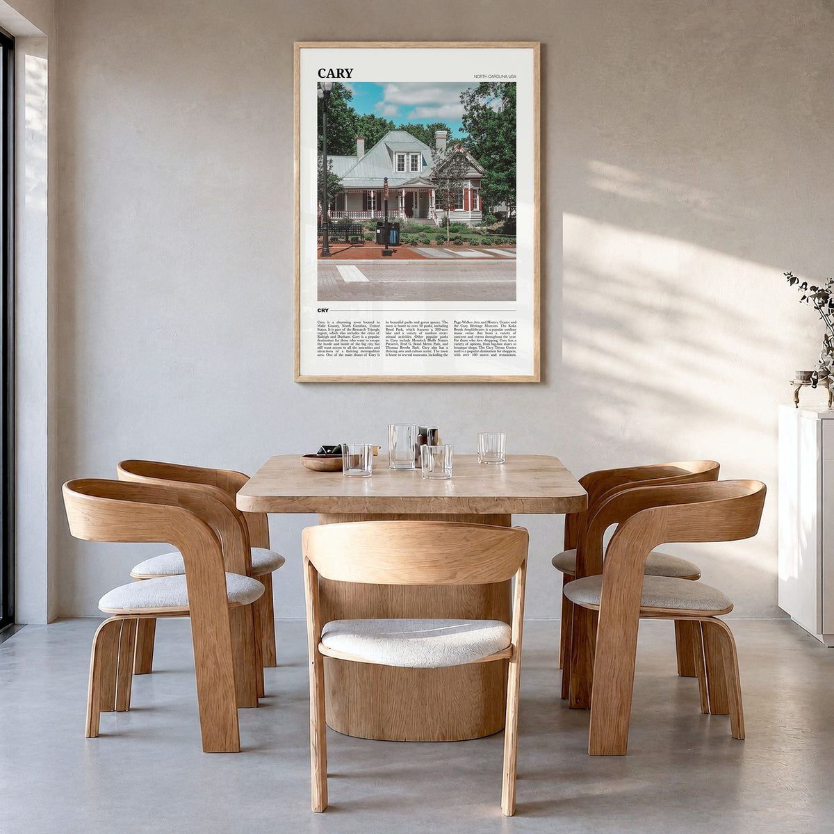 Cary Travel Poster in a natural wood frame, hanging in a dining room