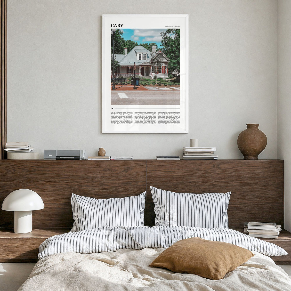 Cary Travel Poster in a white wood frame, hanging in a bedroom