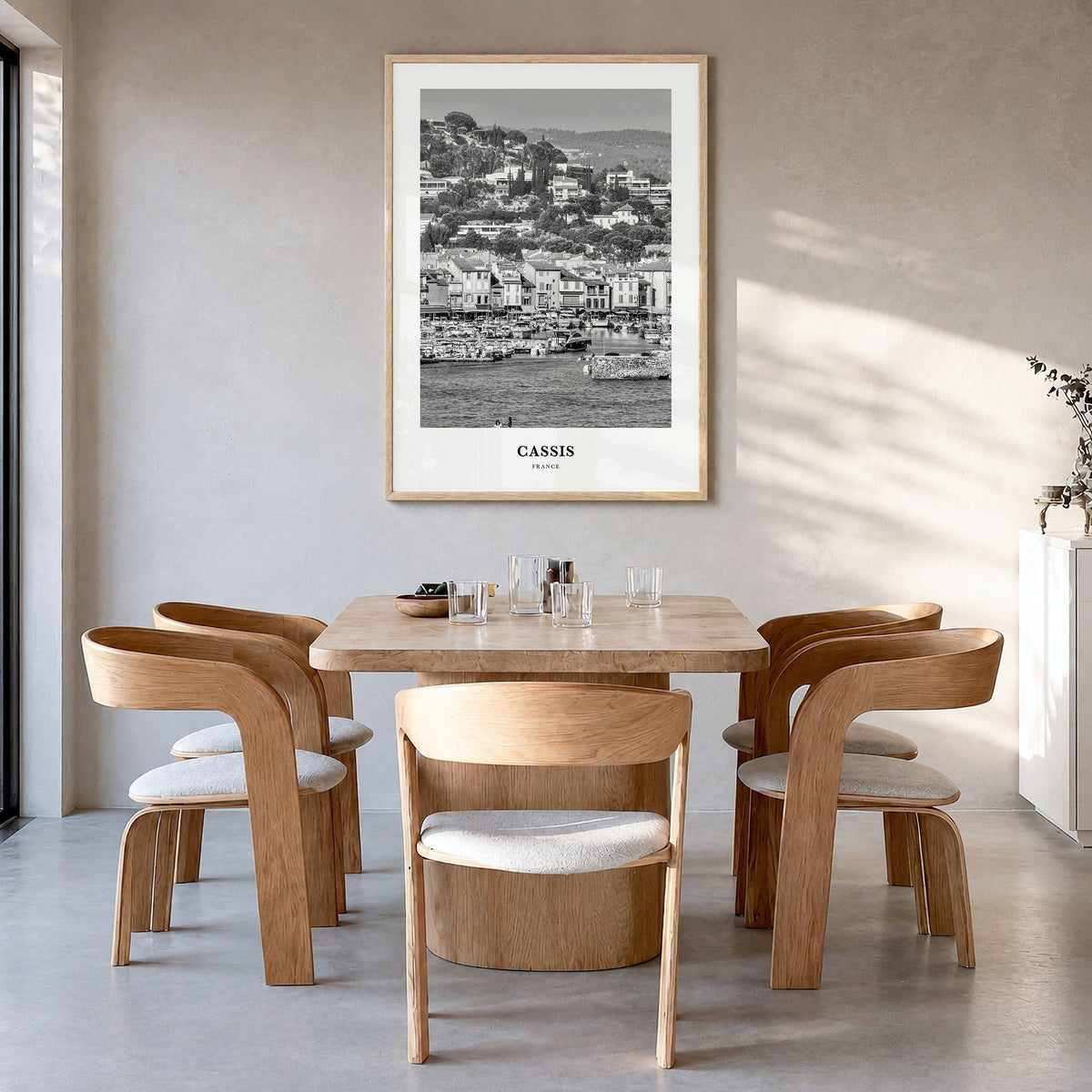 Cassis Classic Poster in a natural wood frame, hanging in a dining room
