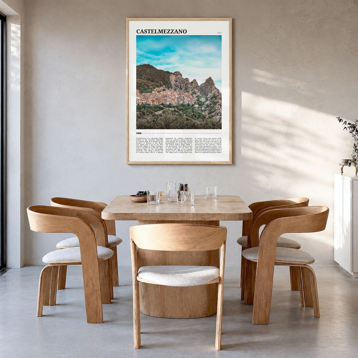 Castelmezzano Travel Poster in a natural wood frame, hanging in a dining room