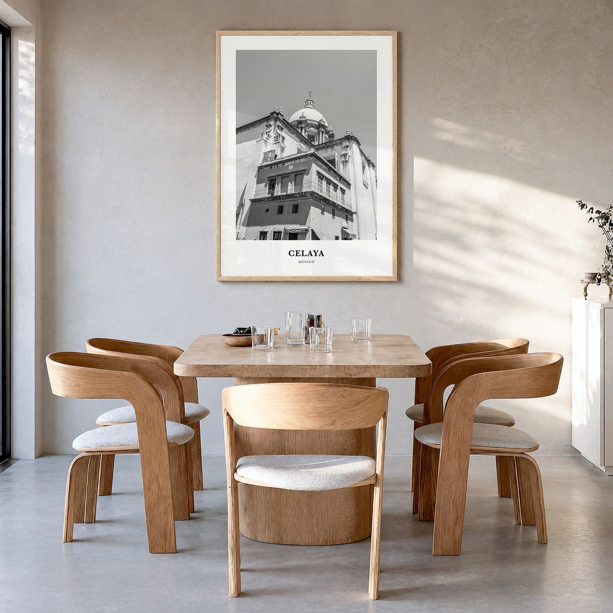 Celaya Classic Poster in a natural wood frame, hanging in a dining room