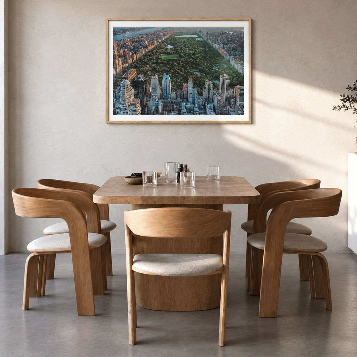 Central Park Photo Poster in a natural wood frame, hanging in a dining room, white border