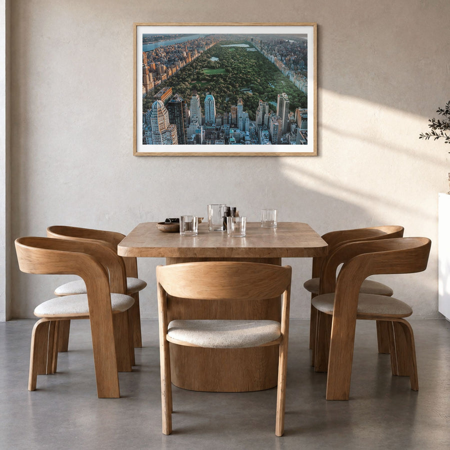 Central Park Photo Poster in a natural wood frame, hanging in a dining room, white border