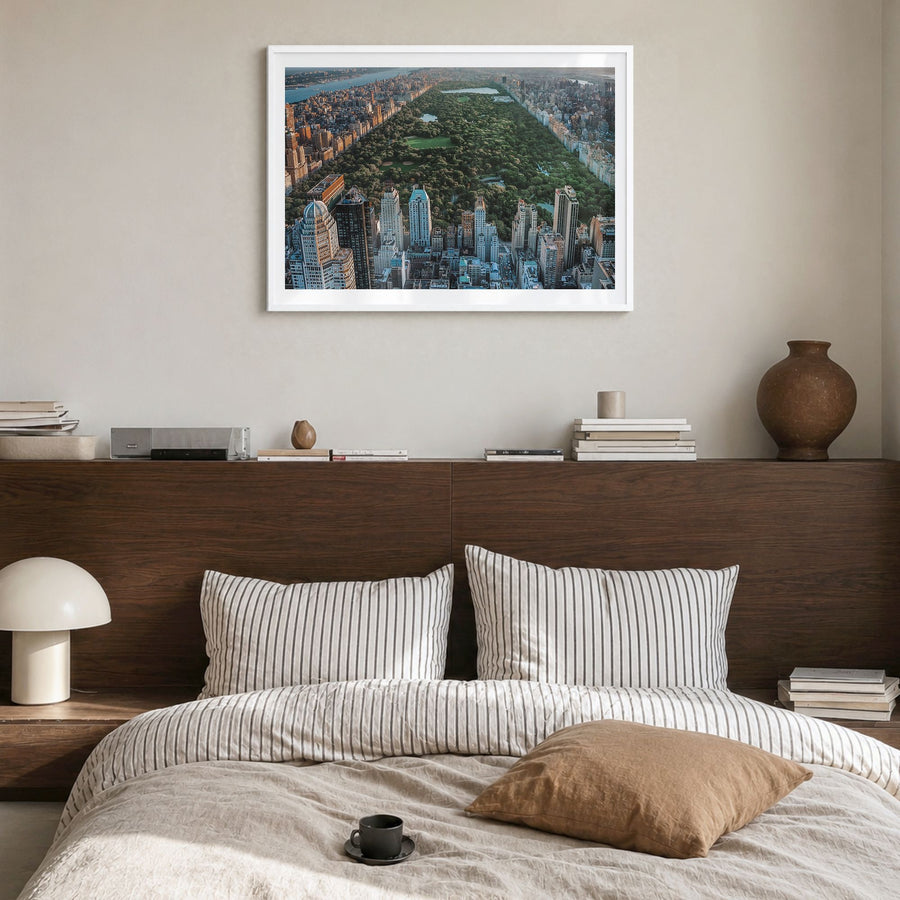 Central Park Photo Poster in a white wood frame, hanging in a bedroom, white border