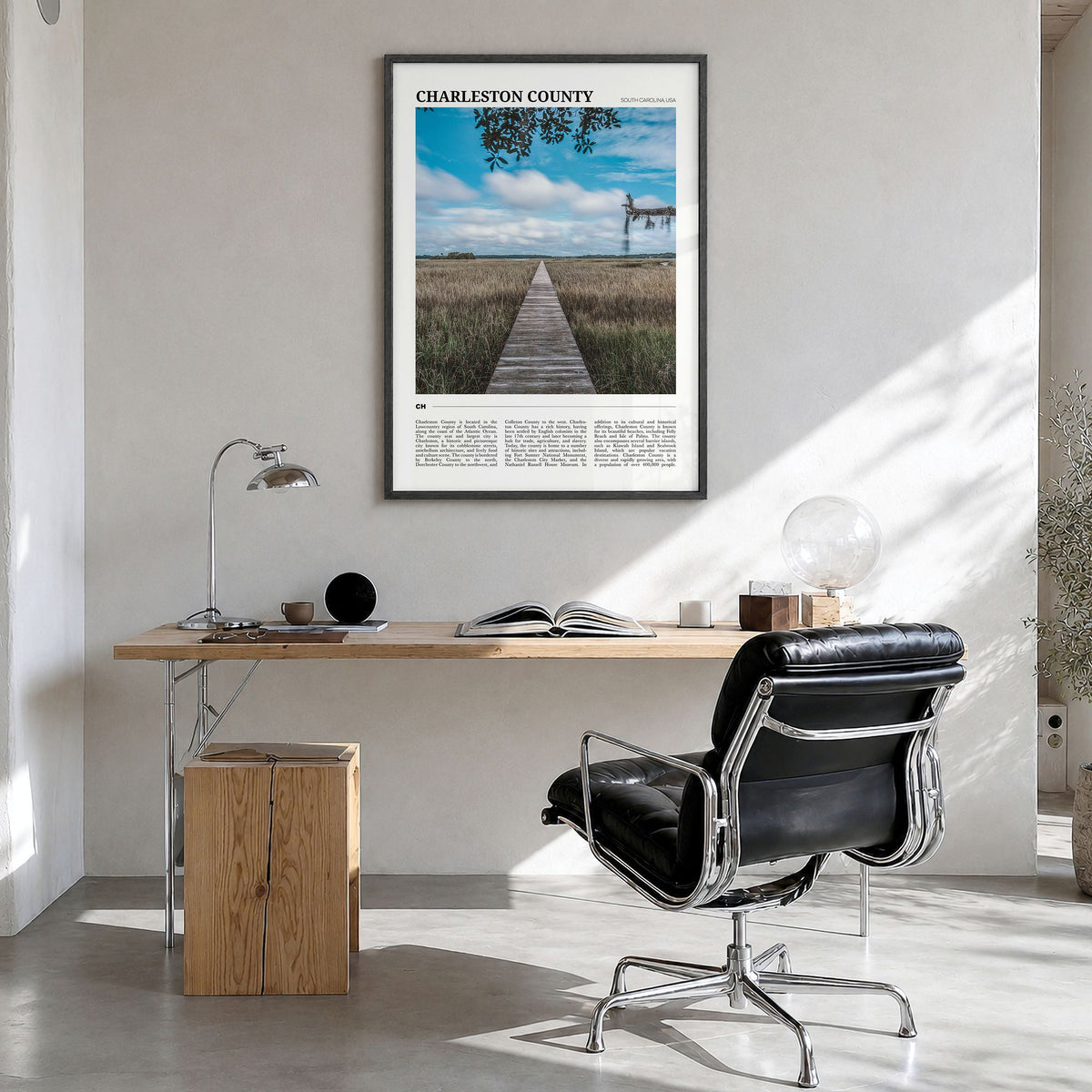 Charleston County Travel Poster in a black wood frame, hanging in a bright home office