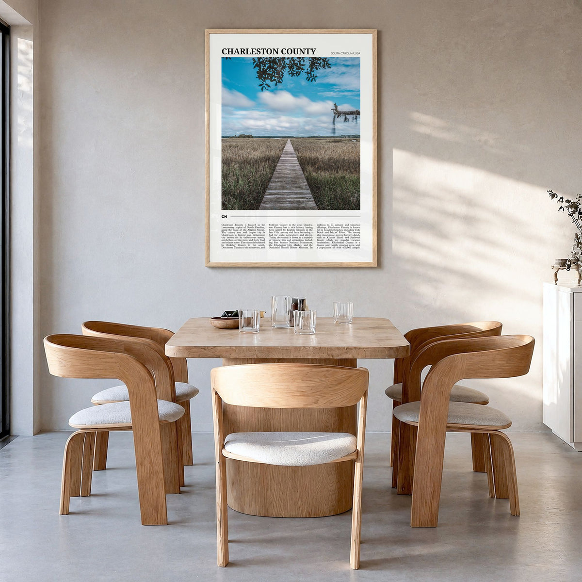 Charleston County Travel Poster in a natural wood frame, hanging in a dining room