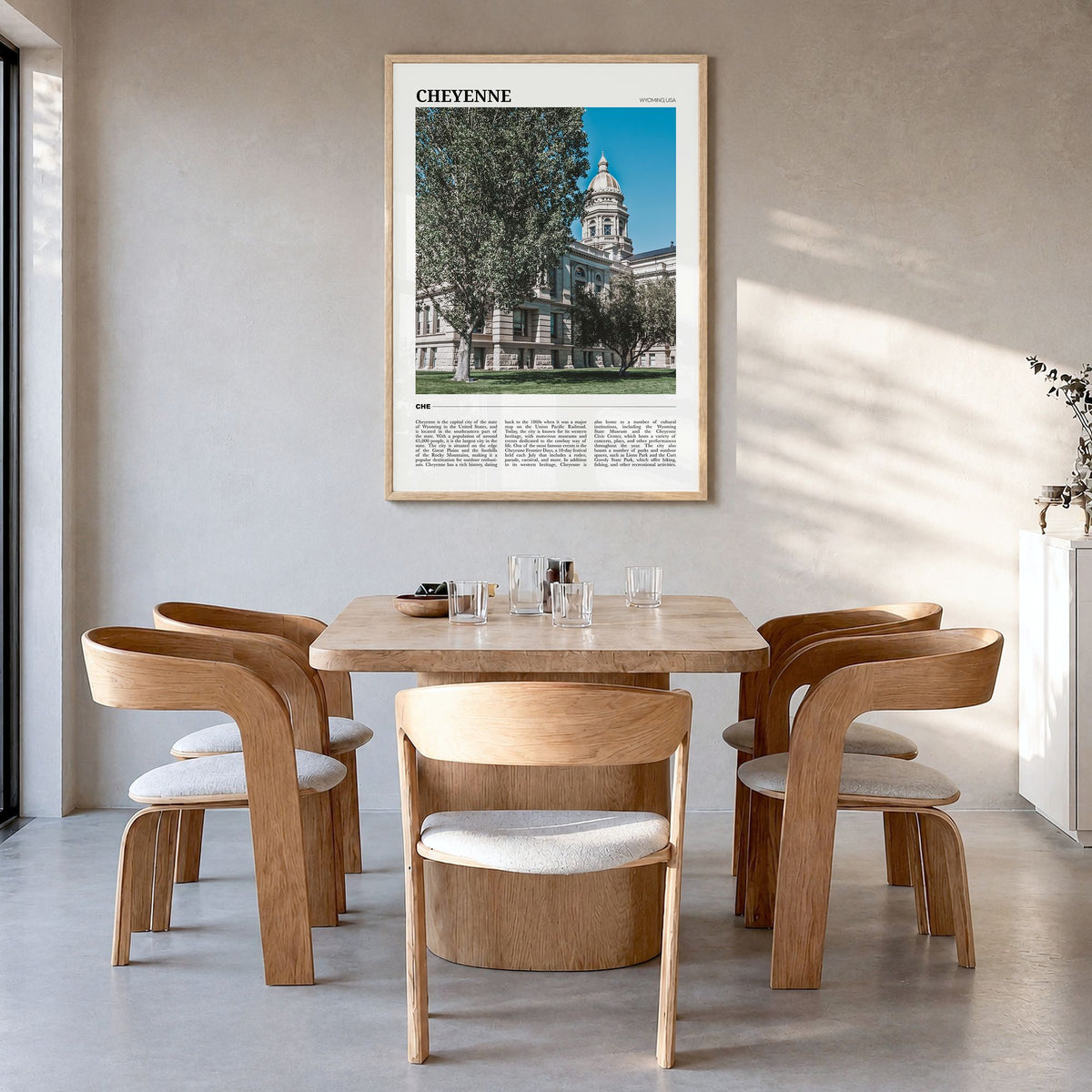 Cheyenne Travel Poster in a natural wood frame, hanging in a dining room