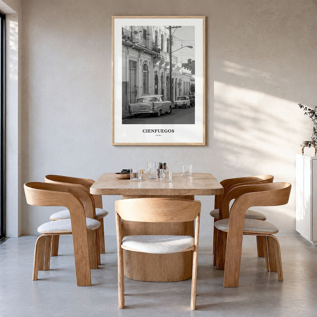 Cienfuegos Classic Poster in a natural wood frame, hanging in a dining room
