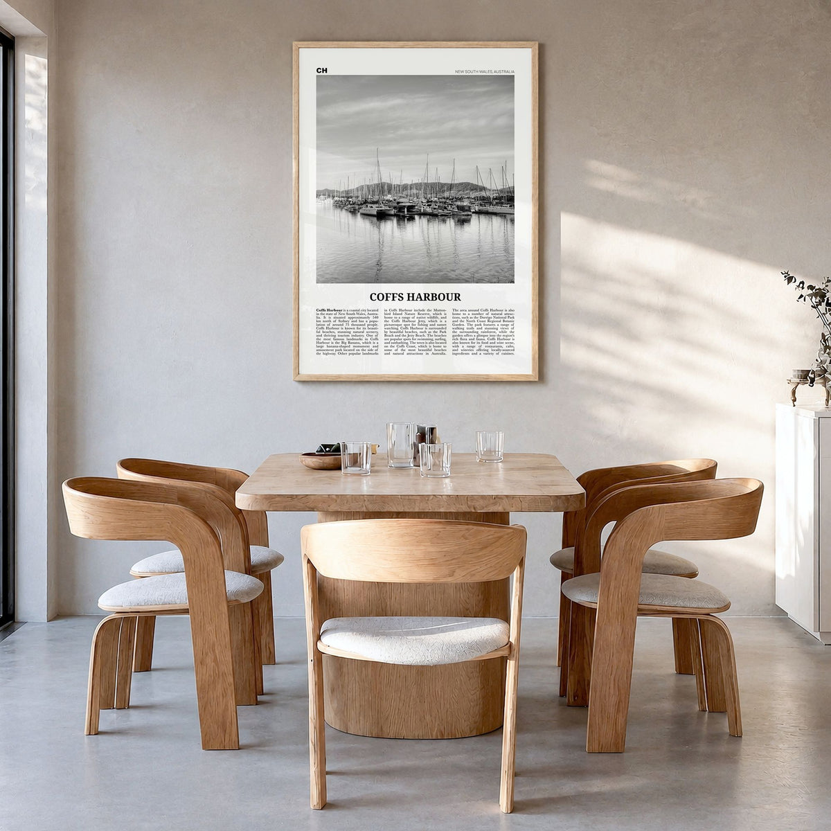 Coffs Harbour Newspaper Poster in a natural wood frame, hanging in a dining room