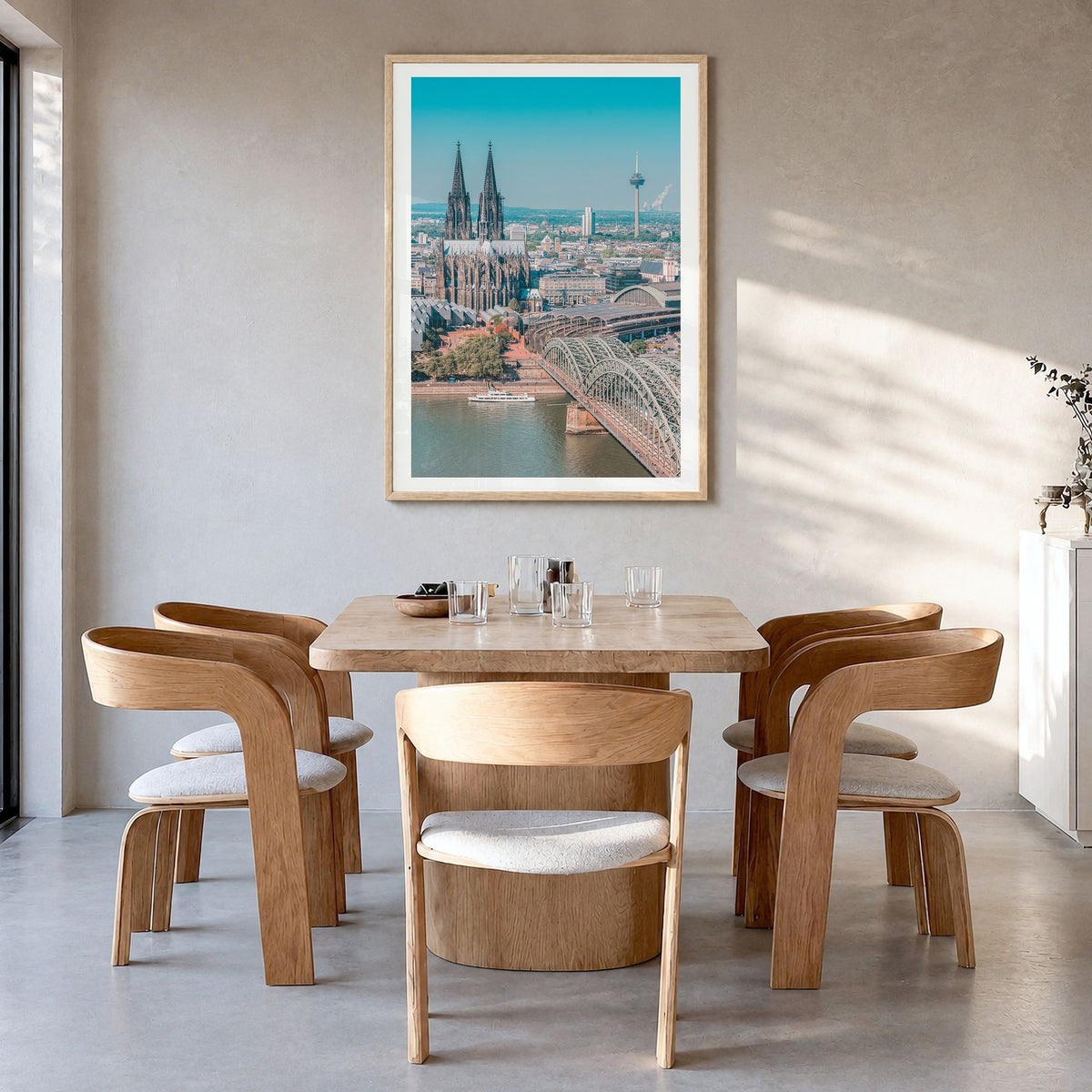 Cologne Photo Poster in a natural wood frame, hanging in a dining room, white border