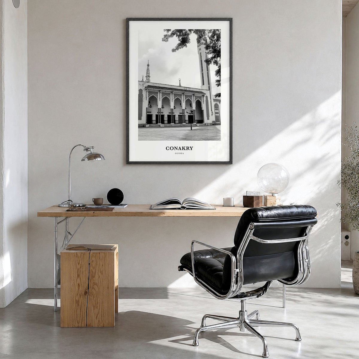 Conakry Classic Poster in a black wood frame, hanging in a bright home office