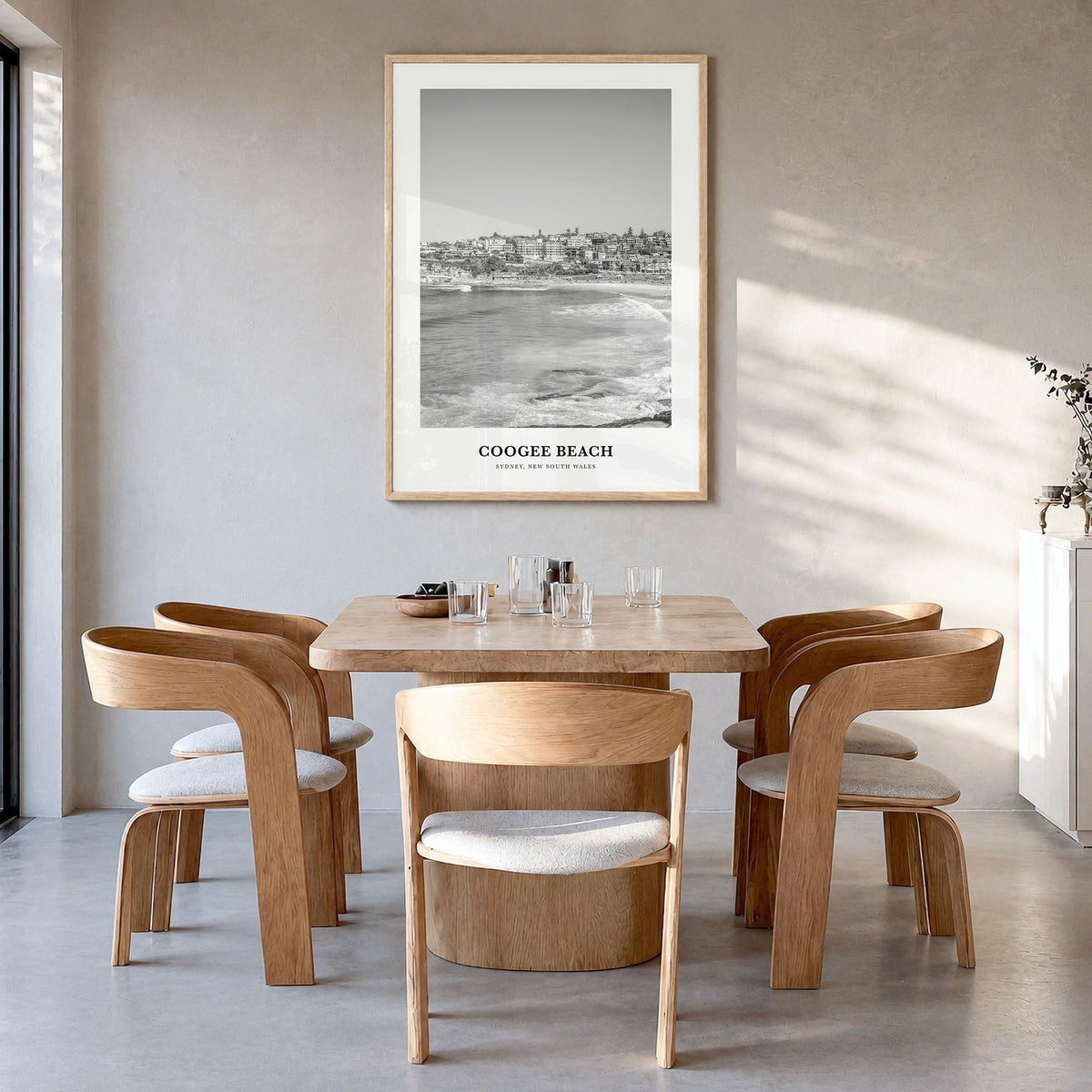 Coogee Beach Classic Poster in a natural wood frame, hanging in a dining room