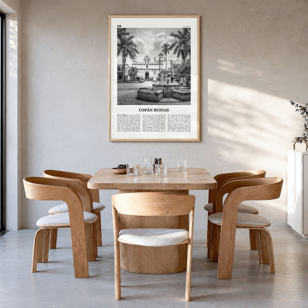 Copán Ruinas Newspaper Poster in a natural wood frame, hanging in a dining room
