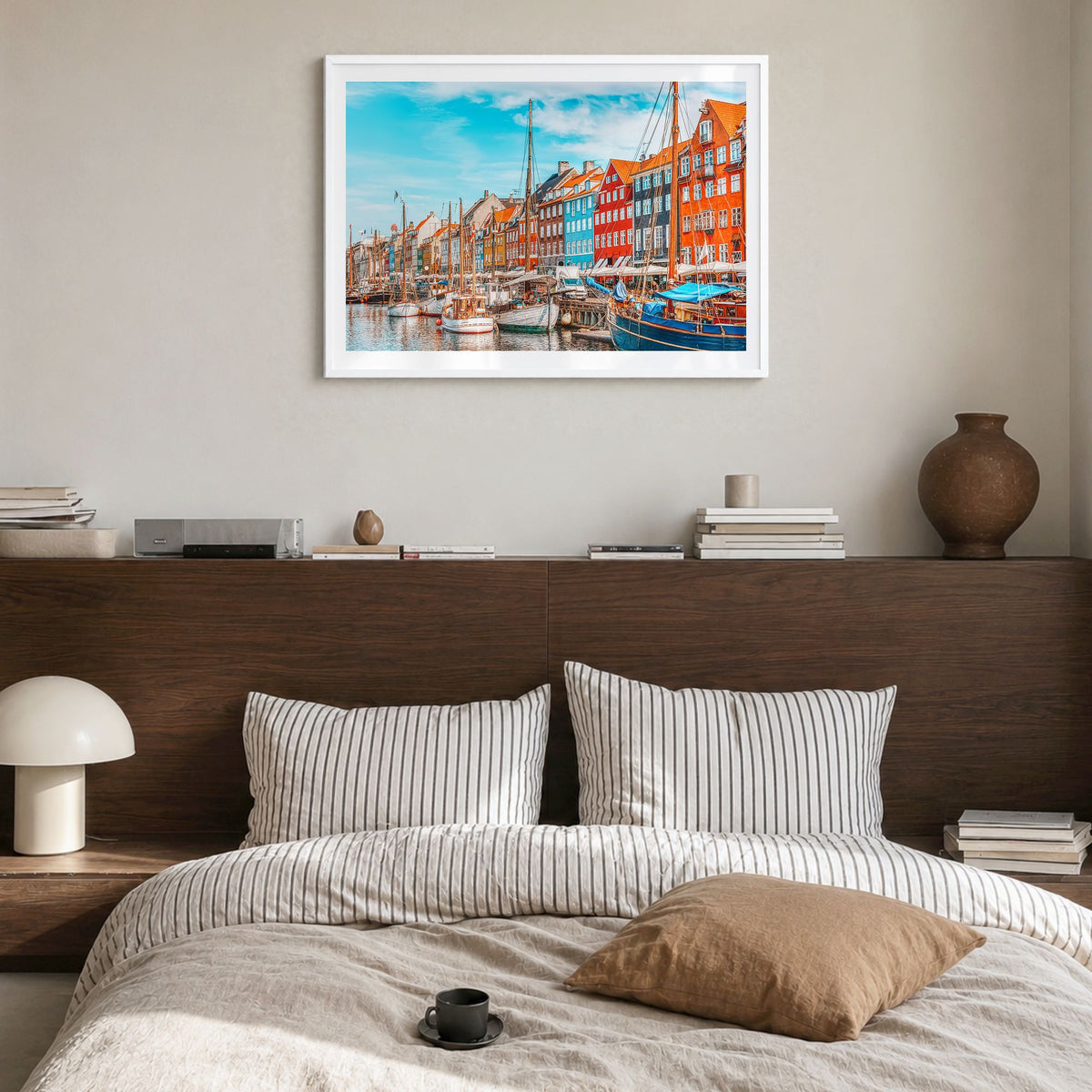 Copenhagen Photo Poster in a white wood frame, hanging in a bedroom, white border