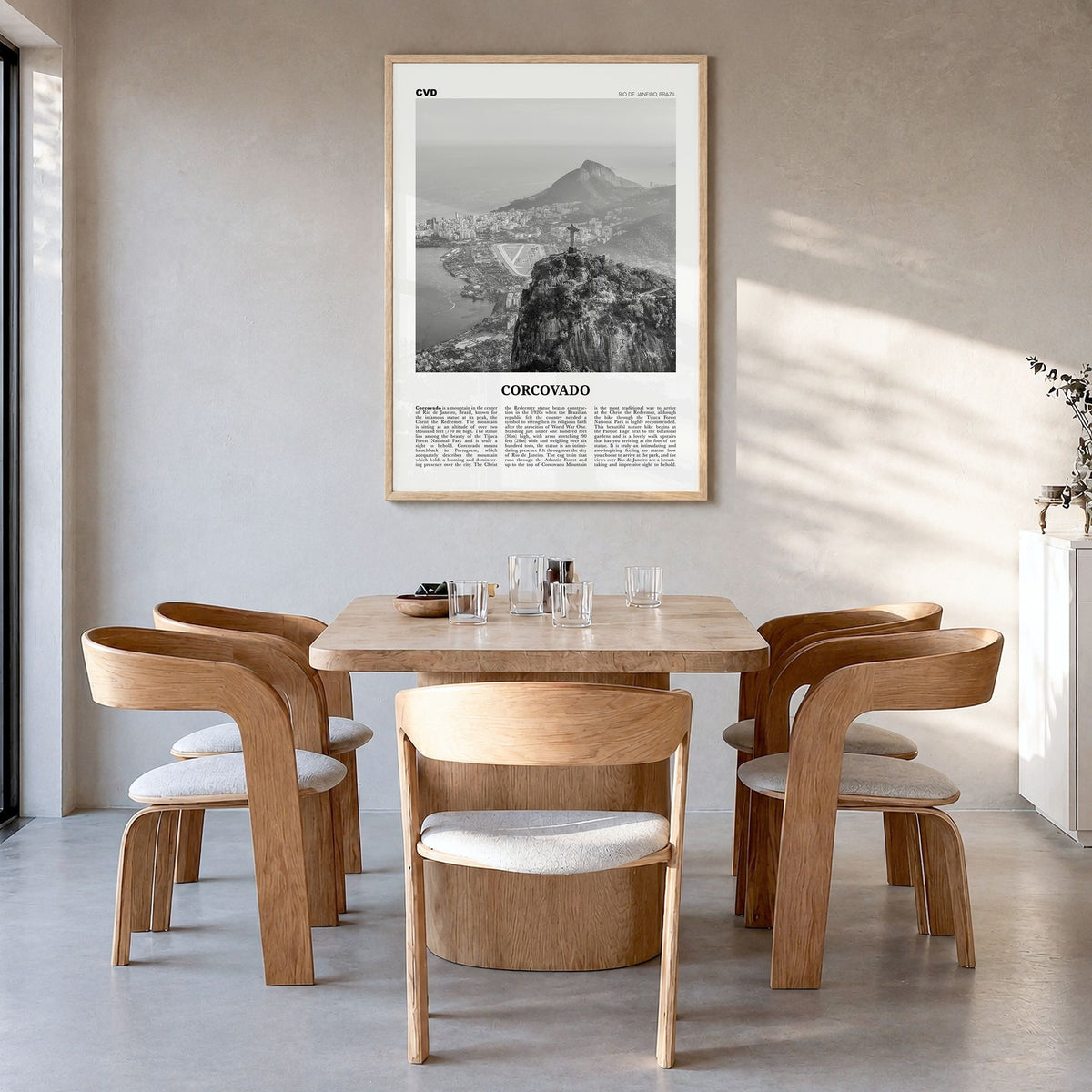 Corcovado Newspaper Poster in a natural wood frame, hanging in a dining room
