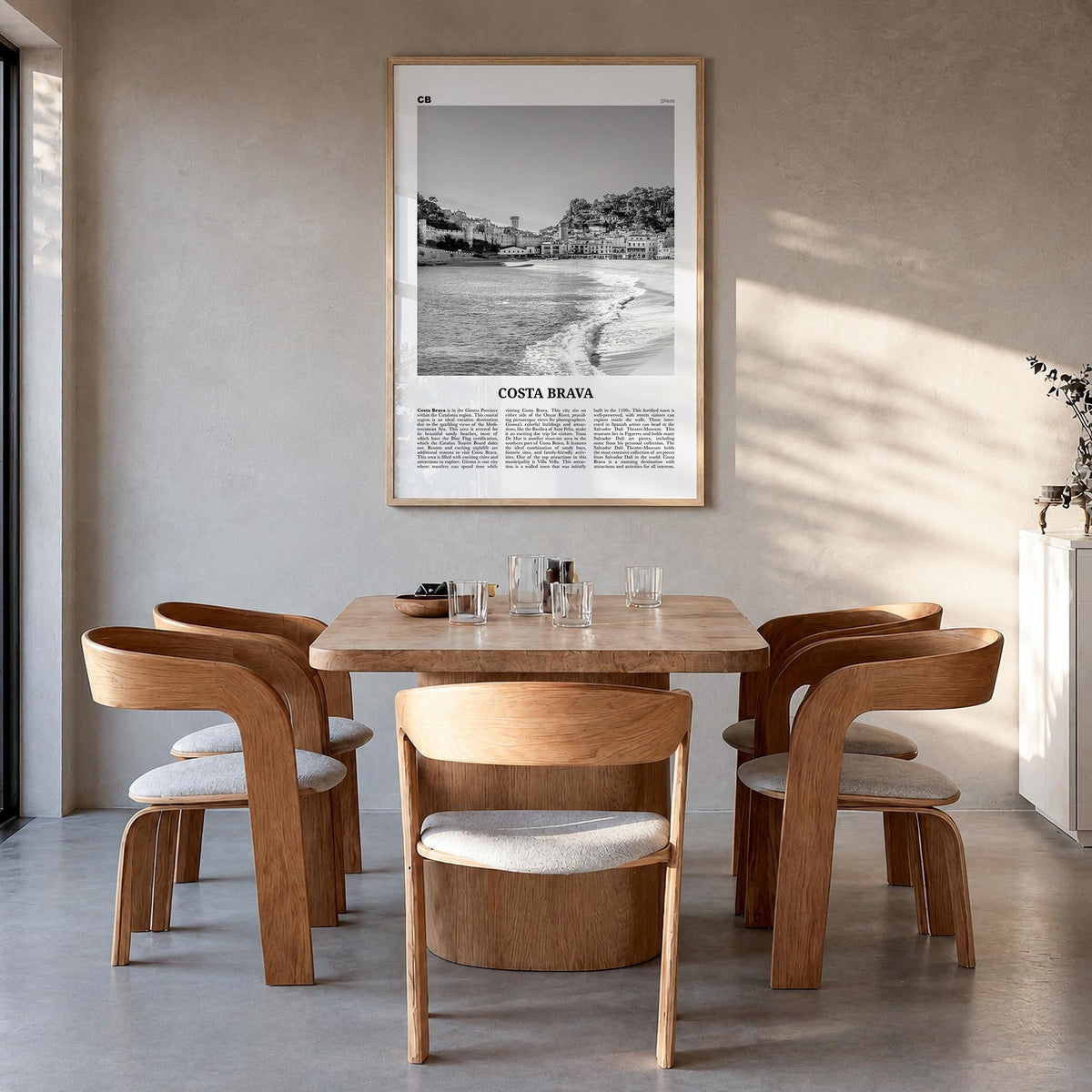 Costa Brava black & white newspaper poster of Spain – vertical wall art in natural wood frame, hanging on wall