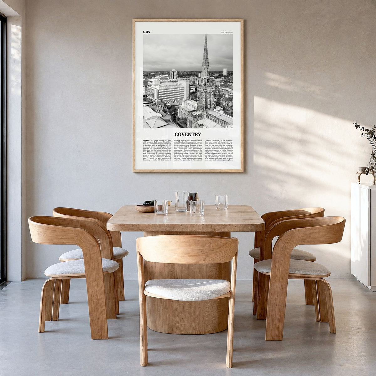 Coventry Newspaper Poster in a natural wood frame, hanging in a dining room