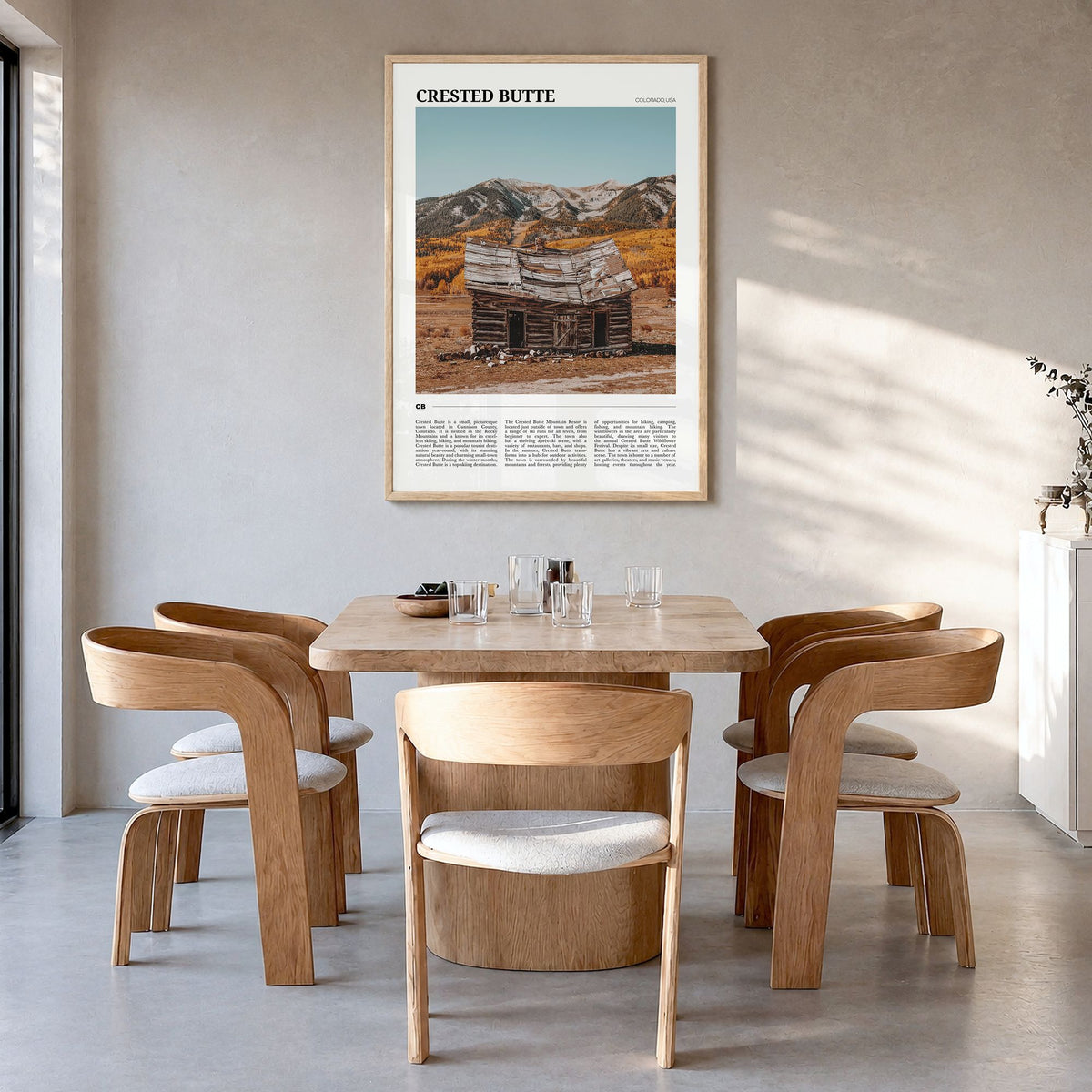 Crested Butte Travel Poster in a natural wood frame, hanging in a dining room