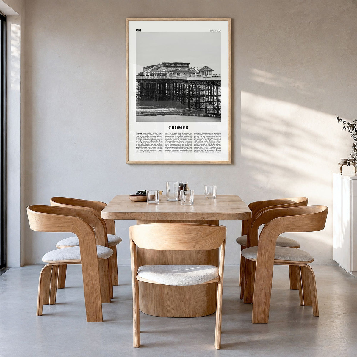 Cromer Newspaper Poster in a natural wood frame, hanging in a dining room