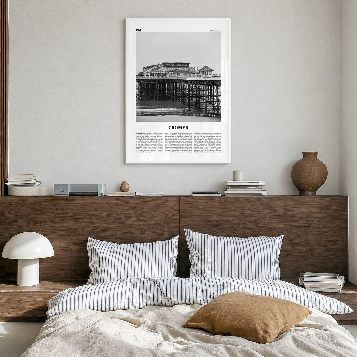 Cromer Newspaper Poster in a white wood frame, hanging in a bedroom