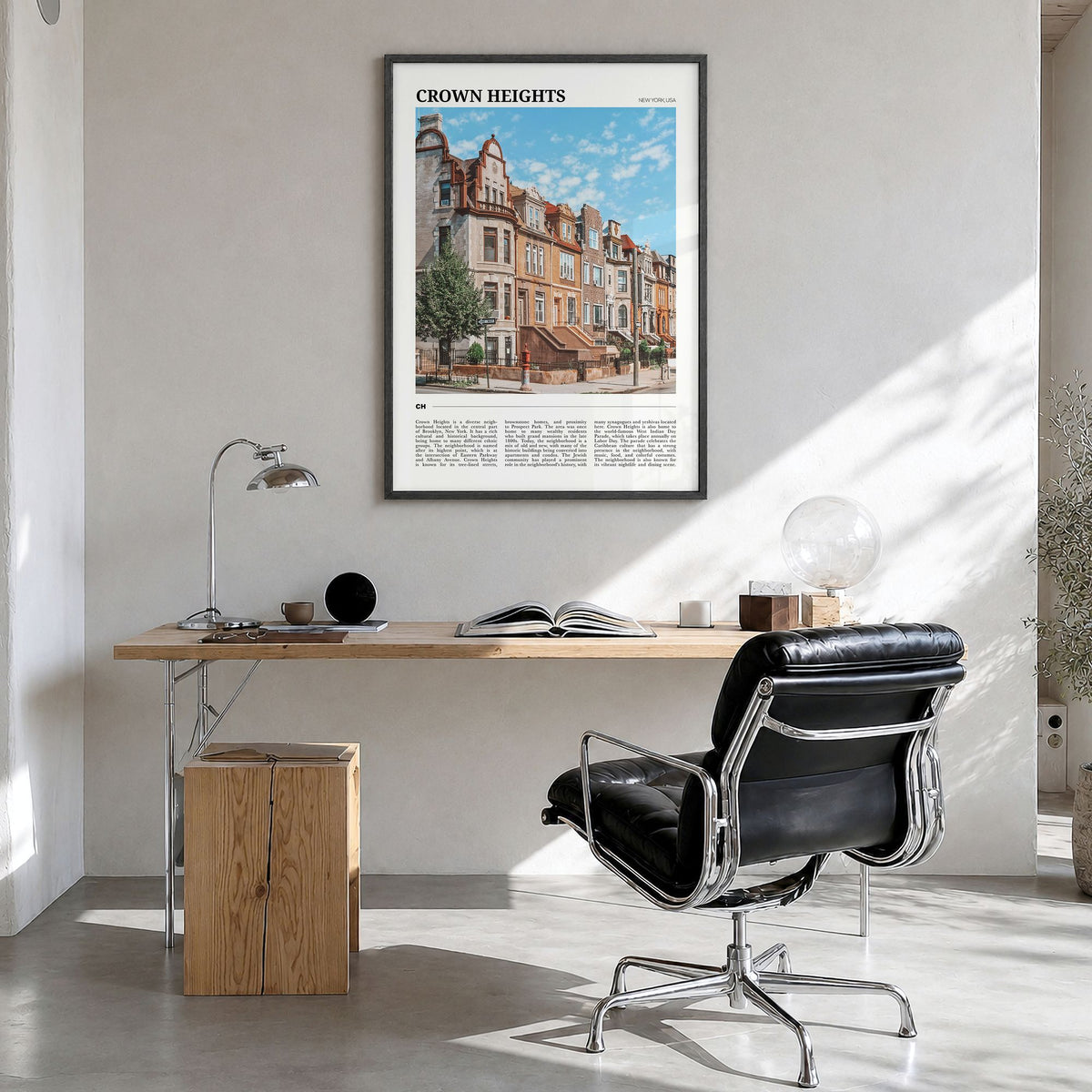 Crown Heights Travel Poster in a black wood frame, hanging in a bright home office