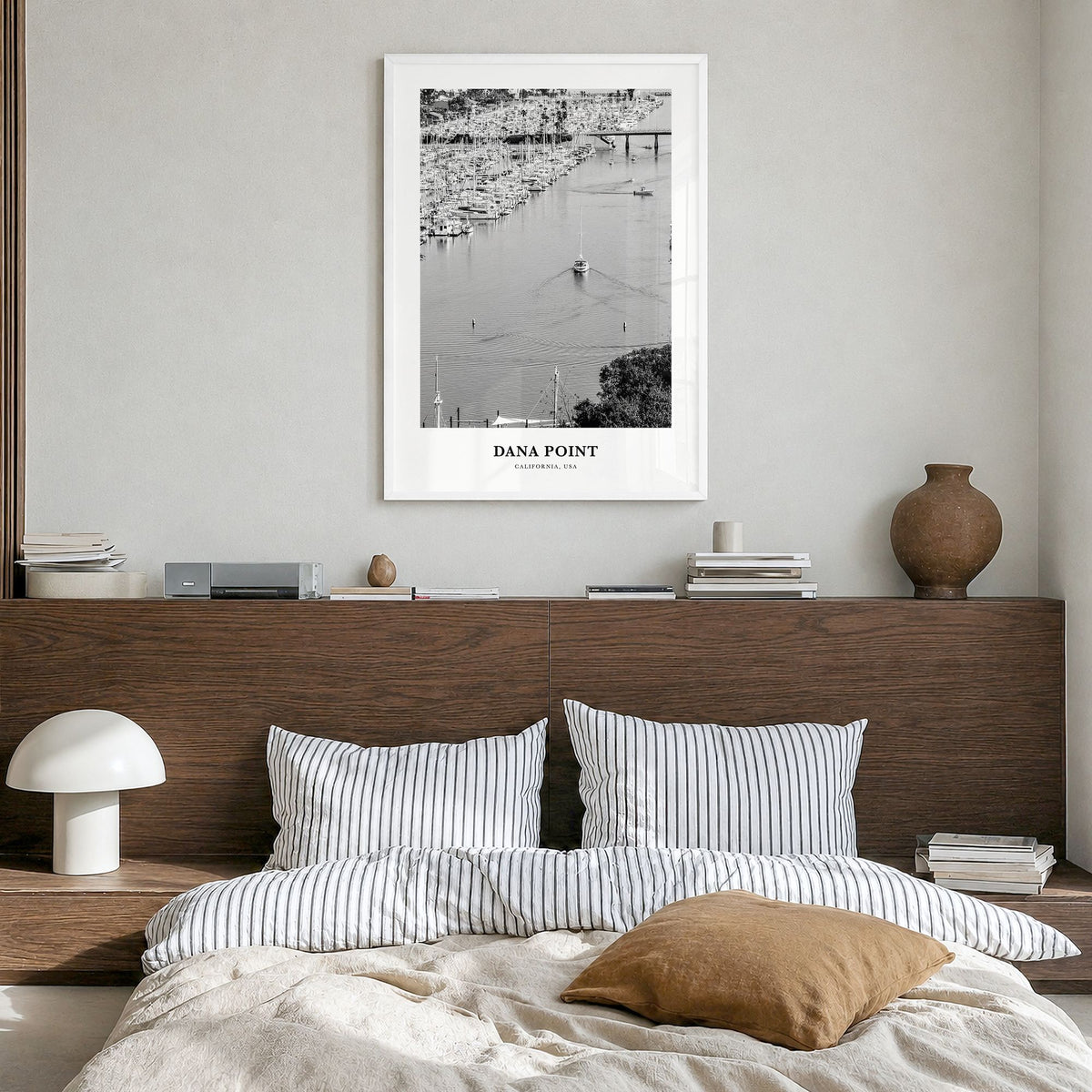 Dana Point Classic Poster in a white wood frame, hanging in a bedroom