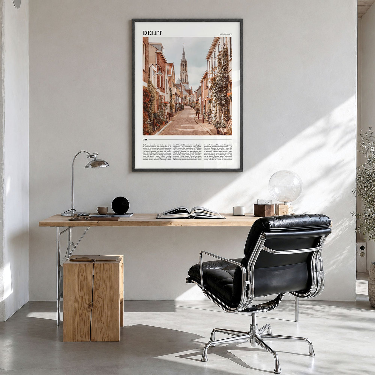 Delft Travel Poster in a black wood frame, hanging in a bright home office