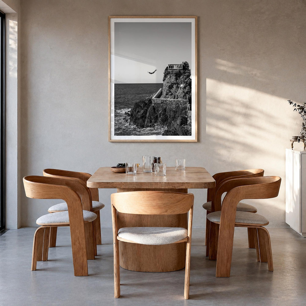 Diving black & white photo poster – vertical wall art in natural wood frame with white border, hanging on wall